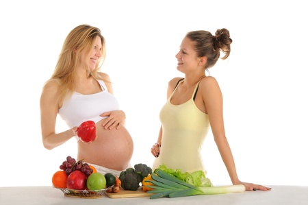 Two gay girlfriends with fruits and vegetables isolated on whiteの写真素材