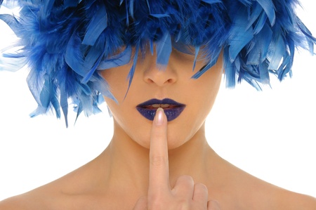 woman with blue feathers lips and closed eyesの写真素材