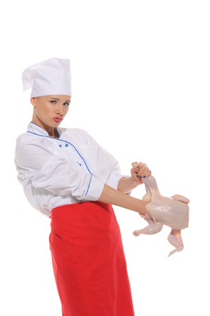 woman- cook  put her hand to raw chickenの写真素材