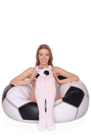 woman with soccer ball on an inflatable chairの写真素材