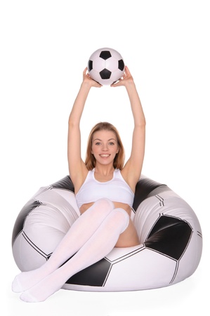 woman with soccer ball on an inflatable chairの写真素材