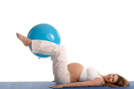 pregnant woman practicing yoga with blue ball isolated on whiteの写真素材