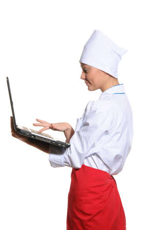 happy woman-cook with laptop isolated on whiteの写真素材