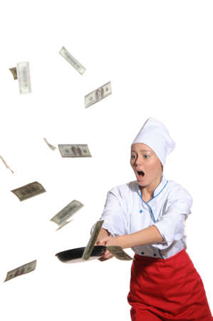 surprised woman-cook frying pan catches money isolated on whiteの写真素材