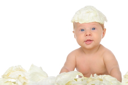 small child sitting among the cabbage leavesの写真素材