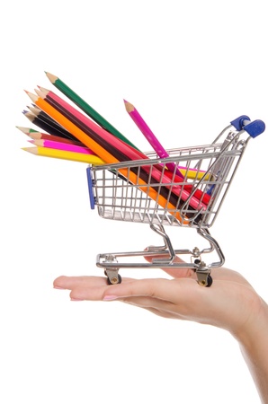 colored pencils in shopping trolley on the palmの写真素材