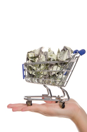 crumpled dollars in shopping trolley on the palmの写真素材