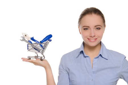 Woman with tools in shopping trolleyの写真素材
