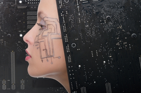 Woman with the motherboard on a black backgroundの写真素材
