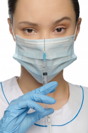 Surprised doctor with syringe isolated on whiteの写真素材