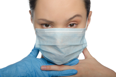 Doctor raised an eyebrow and crossed fingers isolated on whiteの写真素材