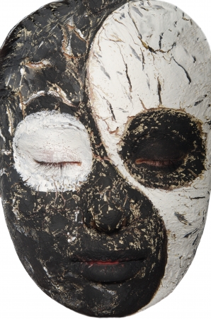 Portrait of an oriental woman in a black and white maskの写真素材