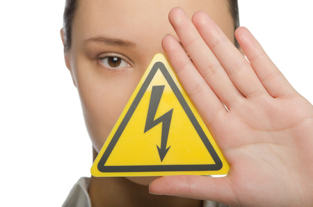 Girl holding a sign lightning in a yellow triangleの写真素材