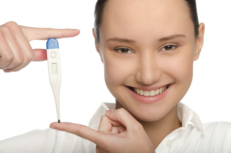 Smiling doctor holding a thermometer isolated on whiteの写真素材