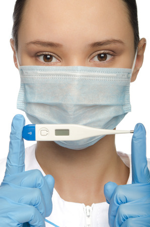 Young nurse is holding a thermometer isolated on whiteの写真素材