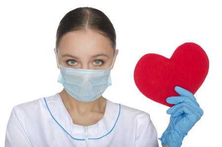 Doctor holding a red heart symbol isolated on whiteの写真素材