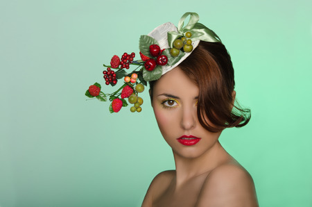 Portrait of young woman in hat with berry decorationの写真素材