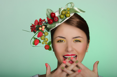 Young woman in elegant hat fingers crossedの写真素材