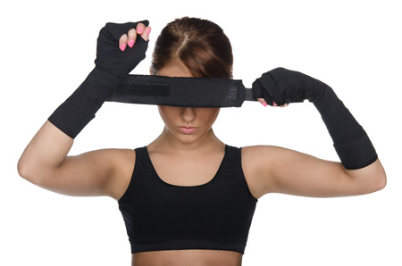Young woman covering her eyes boxing bandagesの写真素材