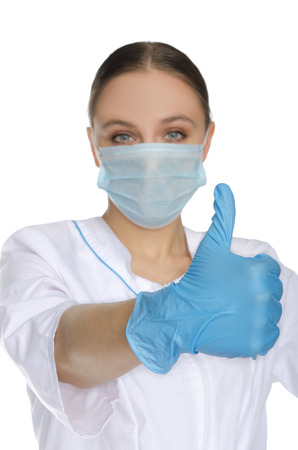 Portrait of doctor in mask and gloves with gesture OKの写真素材