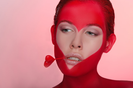 Beautiful woman with picture and heart in your teethの写真素材