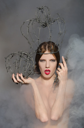 Queen in fog with symbols power of barbed wireの写真素材