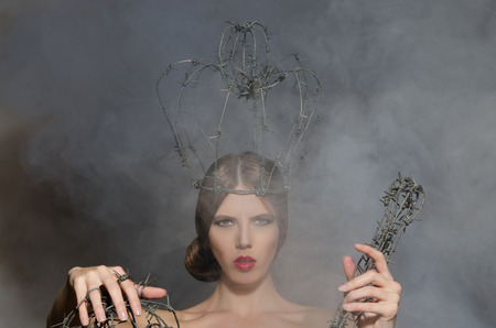 Women in crown and symbols power of barbed wireの写真素材