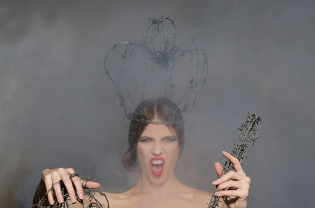 Screaming queen with symbols of power of barbed wireの写真素材