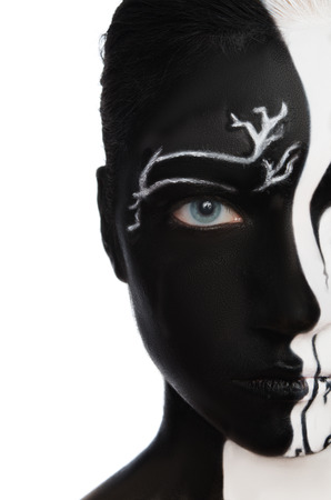 Portrait with black and white colors on face isolated on whiteの写真素材