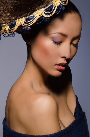  Beautiful Asian girl with eyes closed isolated on the grayの写真素材