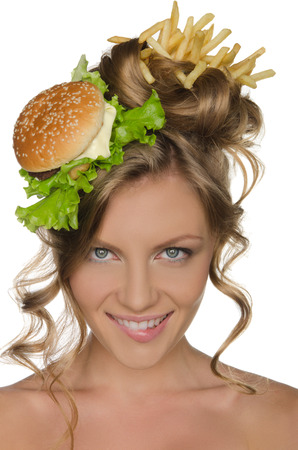 Beautiful woman with burger and fries smilingの写真素材