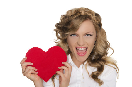 Beautiful young woman holding heart next to himの写真素材