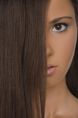 vertical portrait of beautiful brunette woman with straight hairの写真素材
