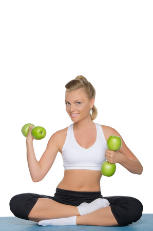 Happy woman with dumbbells of green apples isolated on whiteの写真素材
