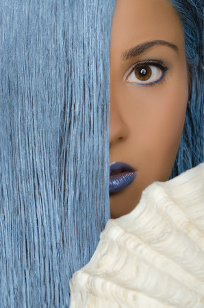 portrait of young woman with long blue hair and large shellsの写真素材