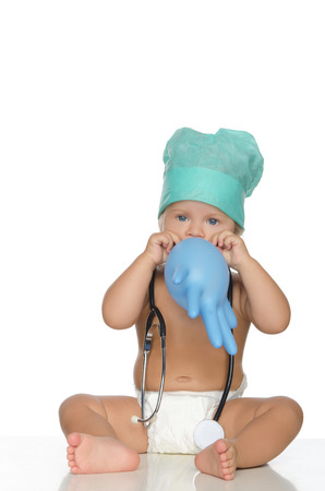 happy child with stethoscope inflate glove isolated on white.の写真素材