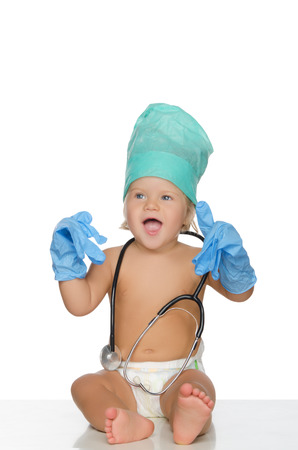 happy child with stethoscope and gloves isolated on white.の写真素材