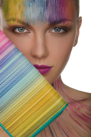 Portrait of european women with colorful purse and face art isolated on whiteの写真素材