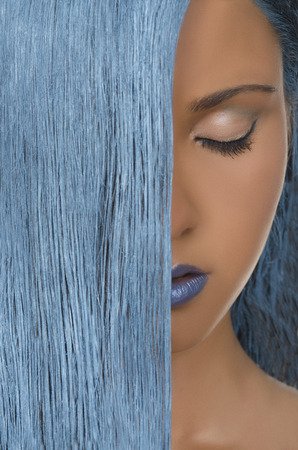 young beautiful woman with straight blue hair, closed eyesの写真素材