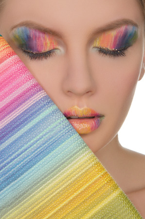 Beautiful face with a color face-up and purse closeupの写真素材