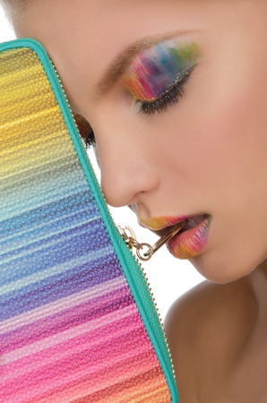 beautiful face with bright face-up and handbag closeupの写真素材