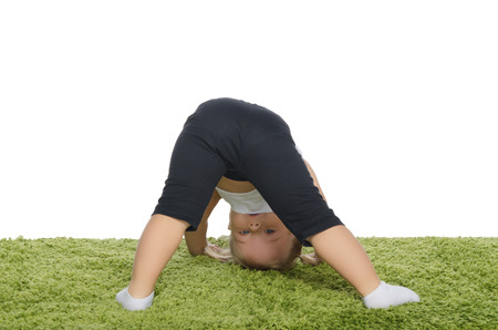 little girl makes the slopes on the green carpetの写真素材