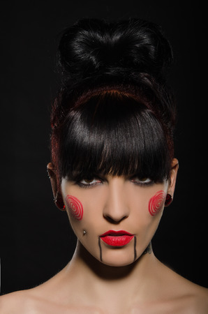 Beautiful brunette with a tattoo on body, dark backgroundの写真素材