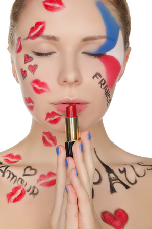 young woman with face art on theme of Paris isolated on whiteの写真素材