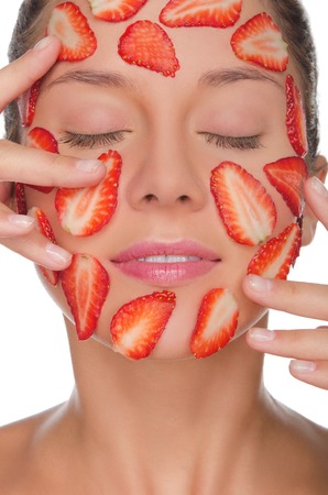 Beautiful woman with mask of strawberries isolated on whiteの写真素材