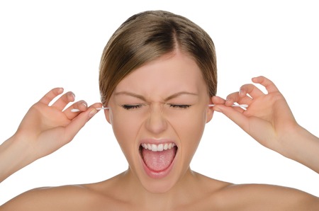 wailing woman cleans ears with cotton sticks isolated on whiteの写真素材