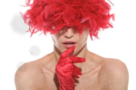 portrait of beautiful woman in wig, gloves and snow isolated on whiteの写真素材