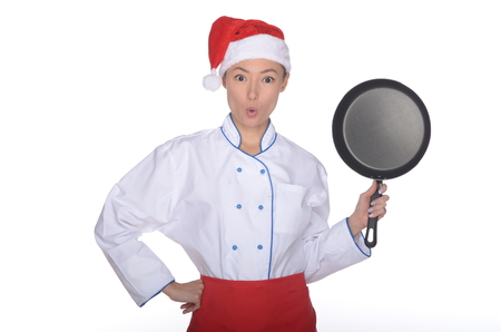 surprised asian chef with frying pan and Christmas hat isolated in whiteの写真素材