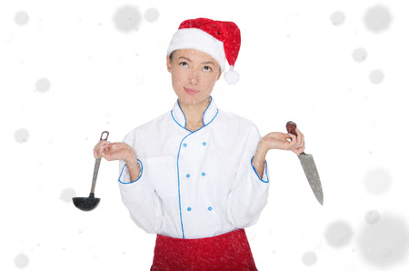 doubtersasian chef in christmas cap with container under snow isolated on whiteの写真素材