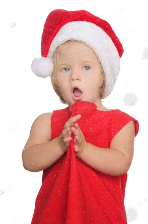 surprised girl in christmas cap in snow isolated on whiteの写真素材